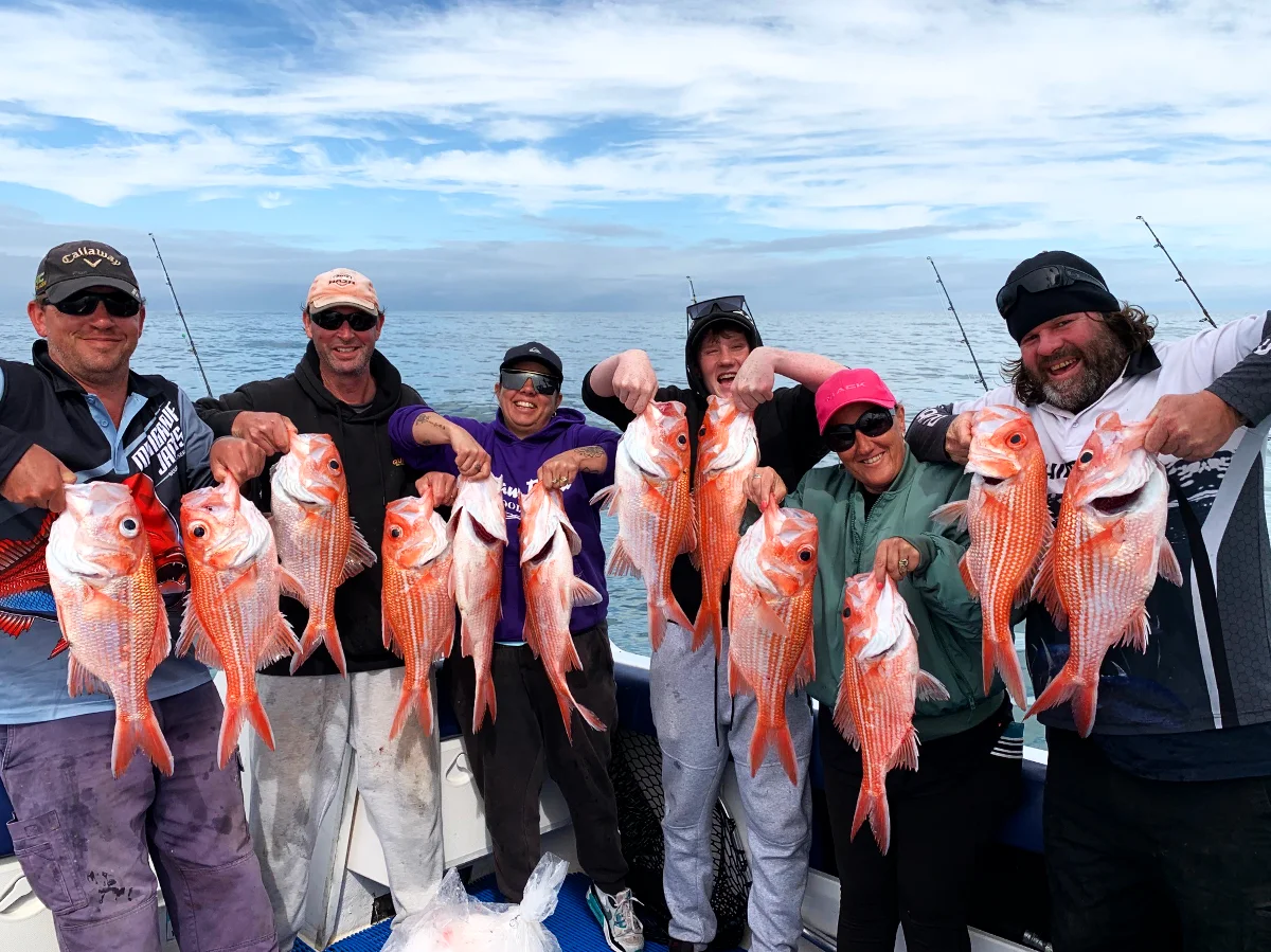 Smiling guests holding up their catch after a GT Fishing Charters trip off Coffin Bay, South Australia