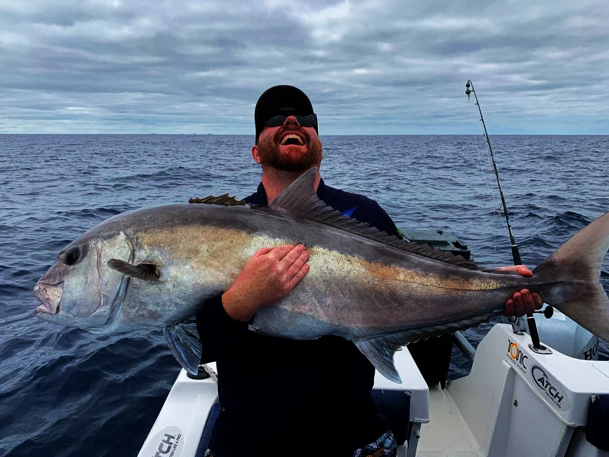 Angler laughing as he hoists a huge catch aboard the charter boat off Coffin Bay