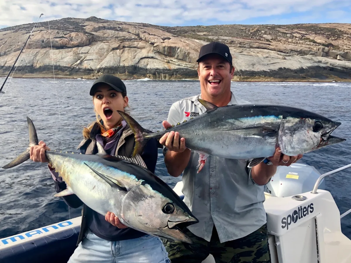 Two anglers holding Bluefin tuna at the island